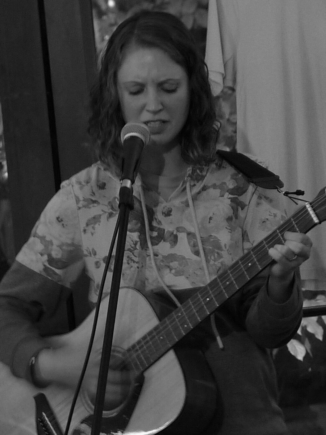 A live singer sharing a song with the room